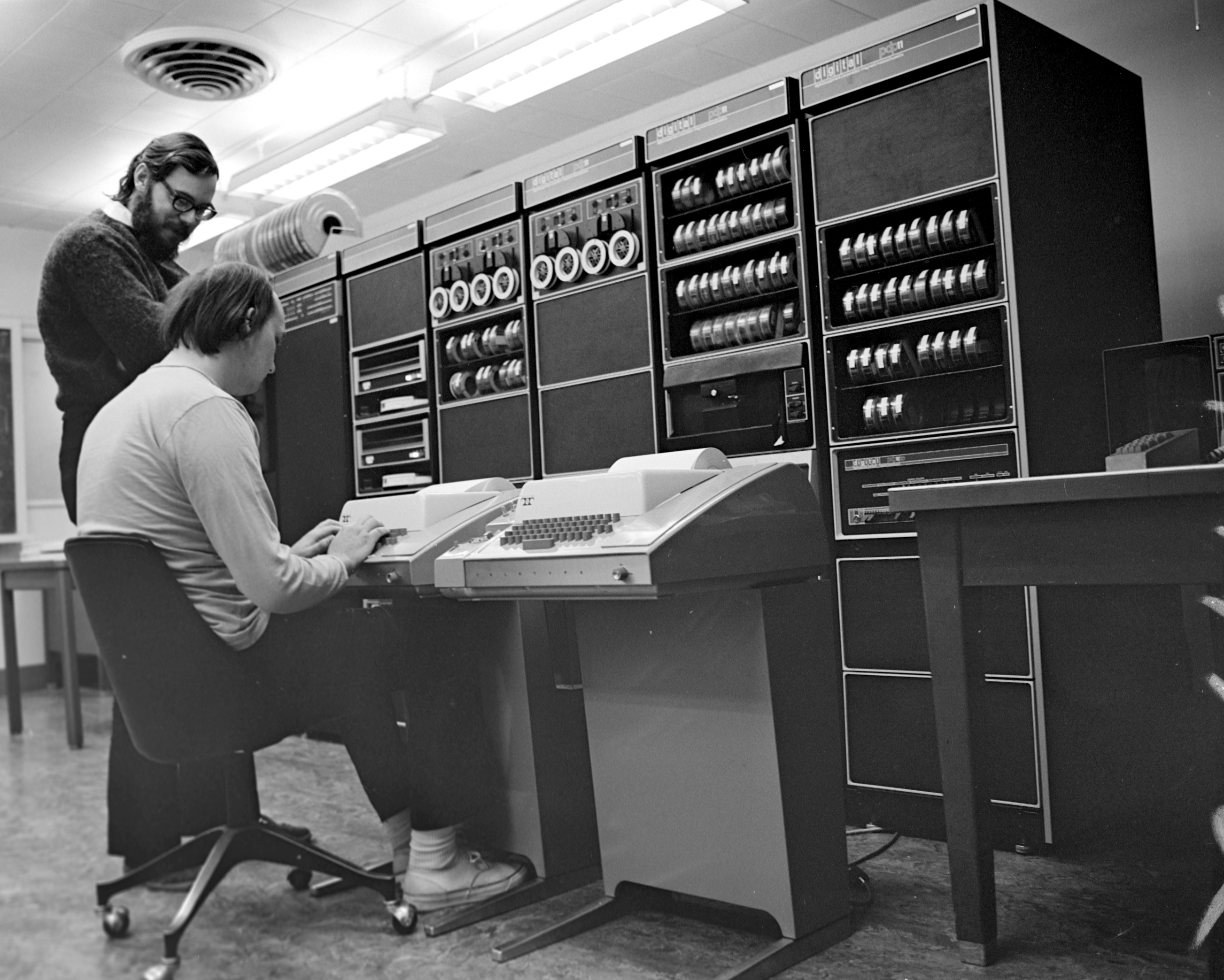 Ken Thompson (sitting) and Dennis Ritchie at PDP 11